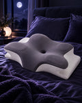 Norevane cervical pillow on indigo bedding in a moonlit bedroom